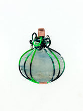 Load image into Gallery viewer, The #224 Green Aventurine Pumpkin by Copper Den Stone Jewelry showcases a distinctive pendant with a teardrop-shaped green aventurine stone encased in an elegant swirl of green and pink wire, creating the look of a stylized onion. This nature-inspired piece makes a striking statement against the plain white backdrop.