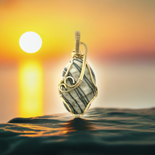 Load image into Gallery viewer, Polished Picasso Stone pendant wrapped in brass wire.
