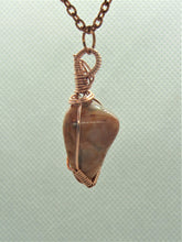 Load image into Gallery viewer, The #159 Feldspar Point pendant by Copper Den Stone Jewelry, featuring Aventurescent Feldspar intricately wrapped in oxidized copper wire, hangs elegantly from a copper chain against a subtly textured light gray background.